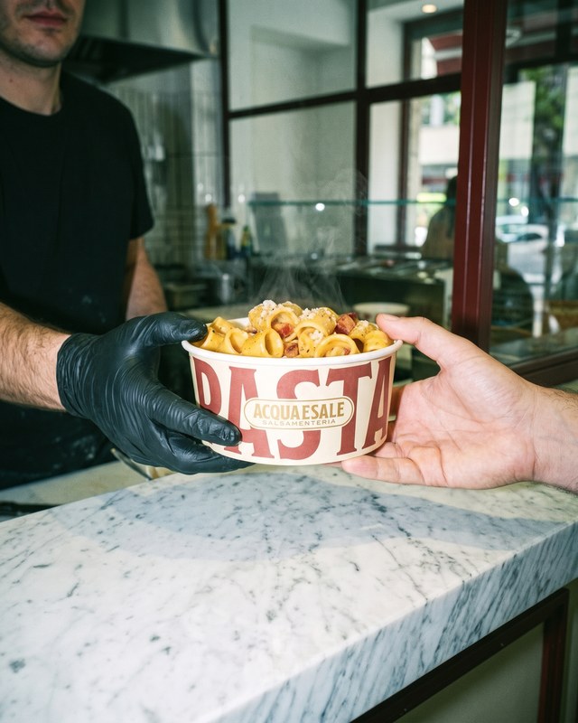 Una bowl passata dal banco al cliente